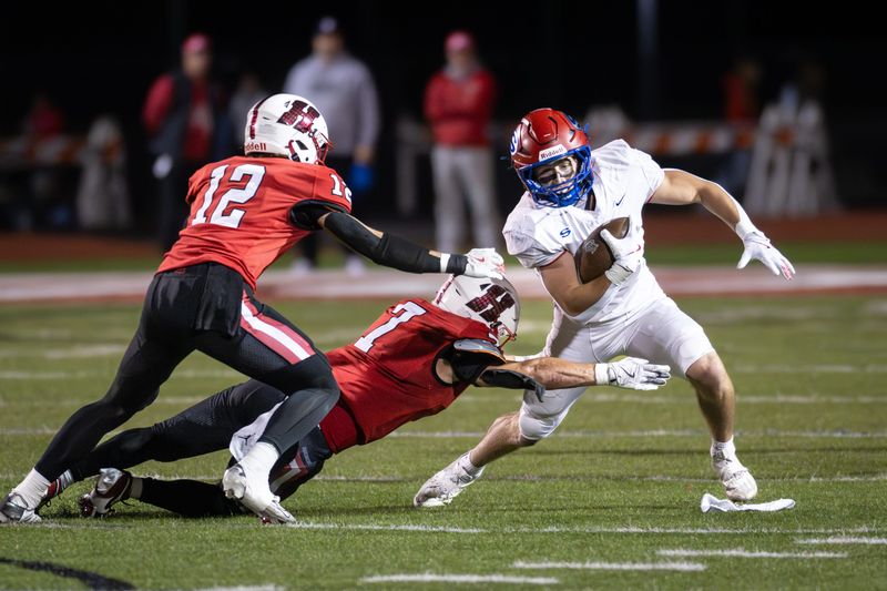 Slinger running back Kobe Hendricks (5) tries to sidestep Homestead linebacker Blake Wichman (7) in a game Friday, October 10, 2025, at Homestead High School in Mequon, Wisconsin.