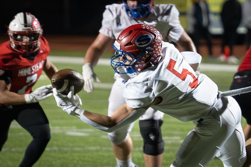 Slinger running back Kobe Hendricks (5) makes a one-handed catch that went for a touchdown against Homestead in a game Friday, October 10, 2025, at Homestead High School in Mequon, Wisconsin.