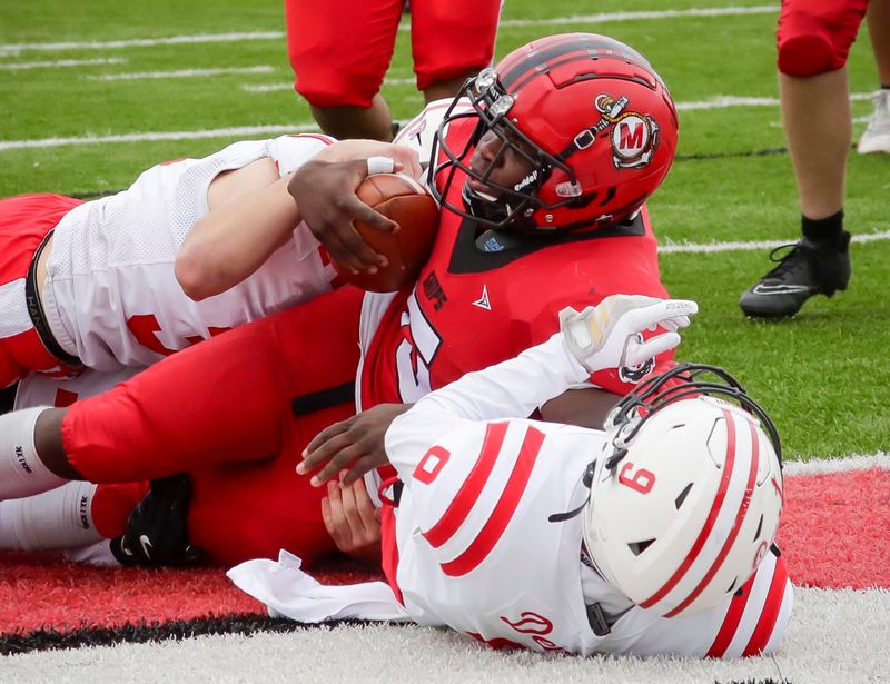 Manitowoc Public School District is launching a student-led effort to design a new district logo for the Ships. Pictured, Manitowoc Lincoln’s Jaquan Foth (5) lands in the end zone for a touchdown over Green Bay East at Ron Rubick Municipal Field on Oct. 11, 2025, in Manitowoc.