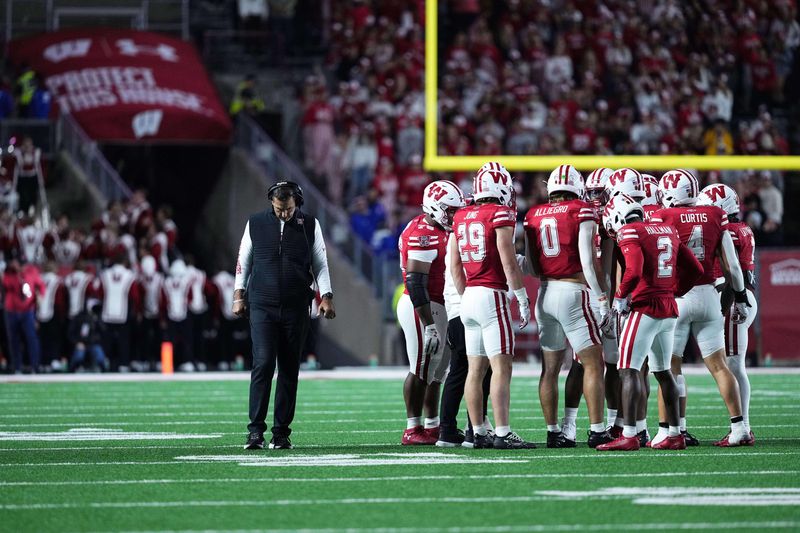 Oct 11, 2025; Madison, Wisconsin, USA; Wisconsin Badgers head coach Luke Fickell and his team take a timeout in the second half against the Iowa Hawkeyes at Camp Randall Stadium. Mandatory Credit: Ross Harried-Imagn Images
