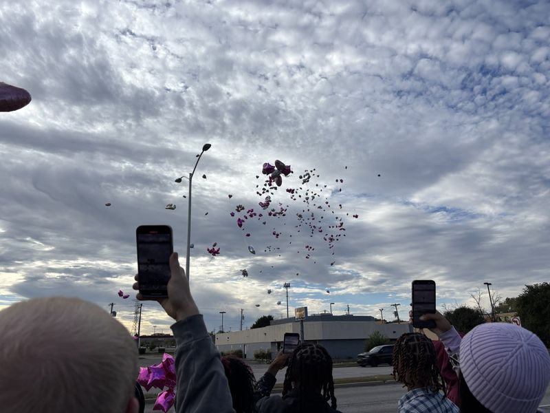 Friends and family gather to release balloons for 25-year-old Keiairra Travis after a hit-and-run killed her on Oct. 11, 2025.
