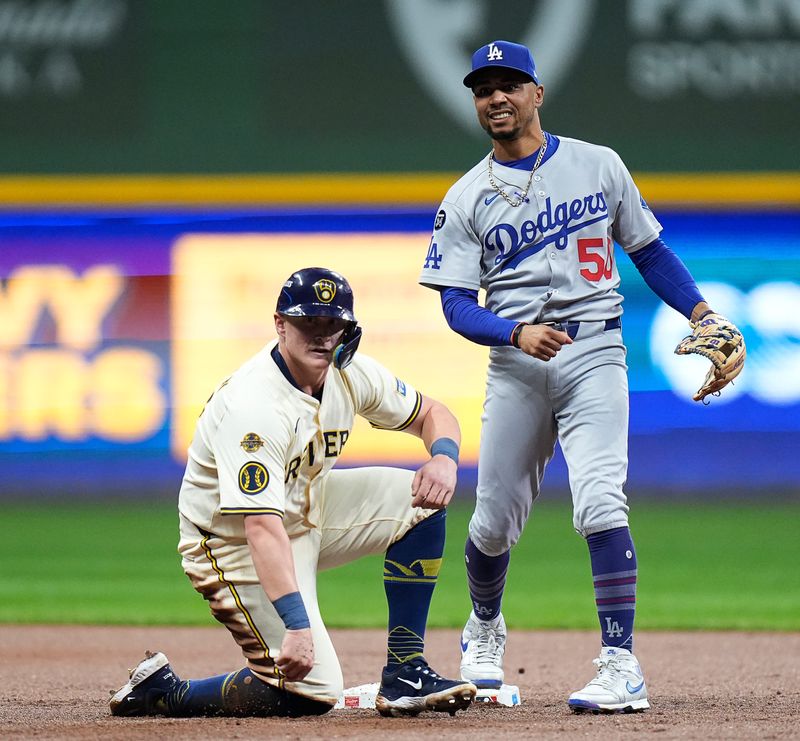 Milwaukee Brewers first baseman Andrew Vaughn (28) is taken out by Los Angeles Dodgers shortstop Mookie Betts (50) during the second inning of the National League Championship Series game October 14, 2025 at American Family Field in Milwaukee, Wisconsin.