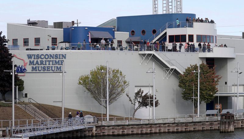 People stand on the deck at the Wisconsin Maritime Museum while waiting for the USS Cobia’s return, Wednesday, October 15, 2025, in Manitowoc, Wis. The USS Cobia spent more than a month in dry dock at Fincantieri Bay Shipbuilding in Sturgeon Bay, Wis. where repairs and painting were done on the submarine.