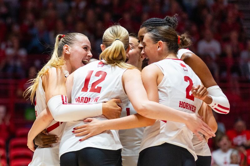 Wisconsin volleyball players celebrate a point in the first set of the ninth-ranked Badgers' sweep over No. 23 UCLA at the UW Field House in Madison on Oct. 17, 2025.