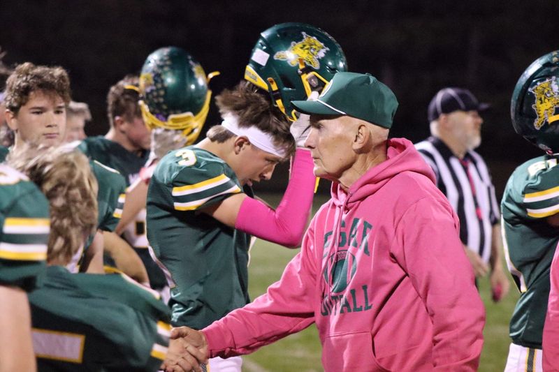 Edgar coach Jerry Sinz shakes hands with assistant coaches Maverick Butt evades defenders at Edgar High School on Friday, Oct. 17. Edgar beat Abbotsford 28-0 (Alfred Smith III/Wausau Daily Herald).