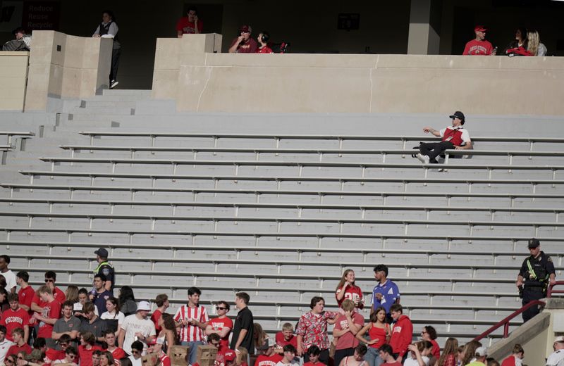 Oct 18, 2025; Madison, Wisconsin, USA; A man has a large seating area to himself during the second quarter of the Wisconsin - Ohio State football game at Camp Randall Stadium.