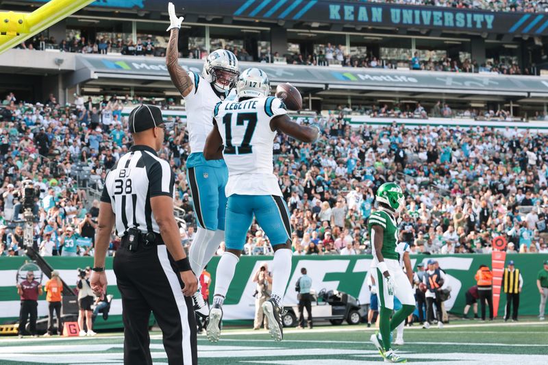 Oct 19, 2025; East Rutherford, New Jersey, USA; Carolina Panthers wide receiver Tetairoa McMillan (4) and wide receiver Xavier Legette (17) celebrate a touchdown in the second quarter against the New York Jets at MetLife Stadium. Mandatory Credit: Vincent Carchietta-Imagn Images