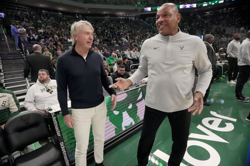 Milwaukee Buck co-owner Wes Edens, left, speaks with head coach Doc Rivers before a game this season.