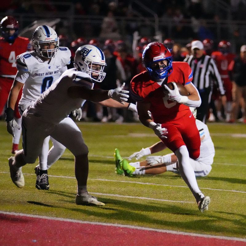 Slinger's Kobe Hendricks (5) scores a touchdown against West Bend West during a WIAA Division 2 playoff game Oct. 24 in Slinger.