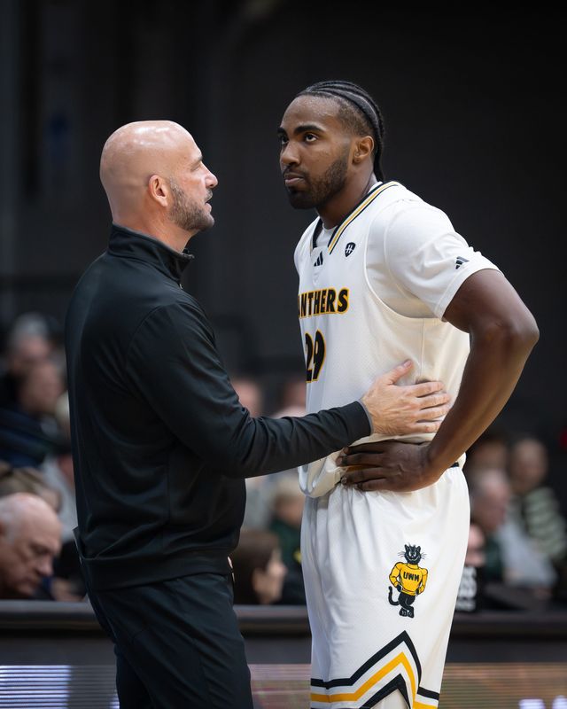 UW-Milwaukee coach Bart Lundy talks with guard Aaron Franklin (29) in an exhibition game against UW-Parkside on Saturday, October 25, 2025, at the Klotsche Center in Milwaukee, Wisconsin.
