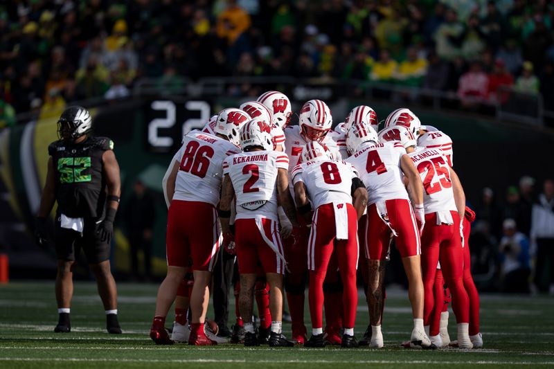 Wisconsin huddles as the Oregon Ducks host the Wisconsin Badgers on Oct. 25, 2025, at Autzen Stadium in Eugene, Oregon.