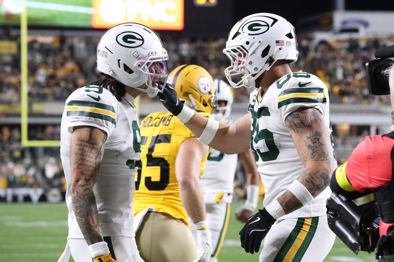 Oct 26, 2025; Pittsburgh, Pennsylvania, USA; Green Bay Packers tight end Tucker Kraft (85) celebrates his touchdown against the Pittsburgh Steelers with wide receiver Christian Watson (9) during the first quarter at Acrisure Stadium. Mandatory Credit: Charles LeClaire-Imagn Images