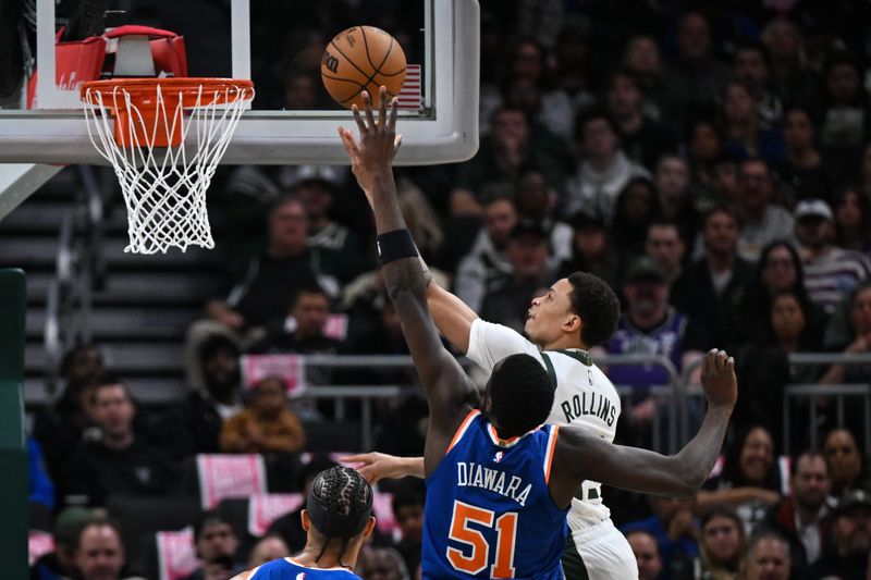 Milwaukee Bucks guard Ryan Rollins (13) drives to the basket past New York Knicks forward Mohamed Diawara (51) to score during the first quarter in a game Tuesday, October 28, 2025, at Fiserv Forum in Milwaukee, Wisconsin.