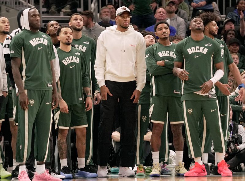 Injured Milwaukee Bucks forward Giannis Antetokounmpo watches from the sidelines in a game against the Golden State Warriors.