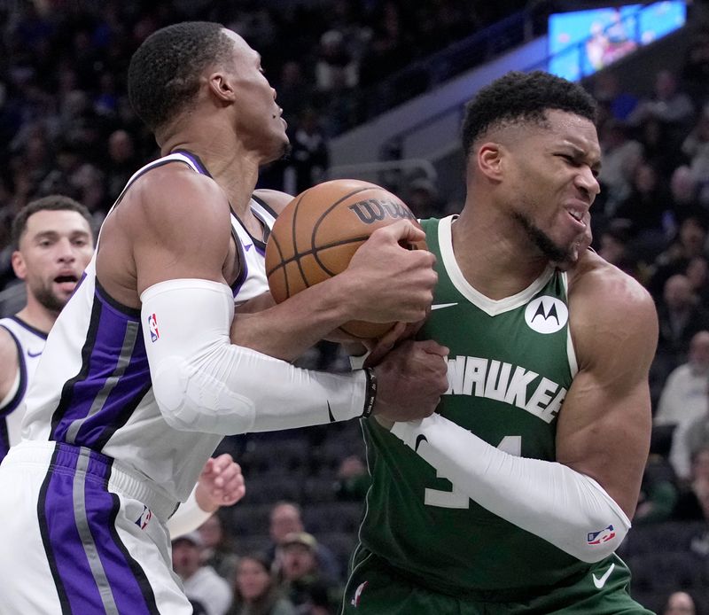 Sacramento Kings guard Russell Westbrook fouls Milwaukee Bucks forward Giannis Antetokounmpo.