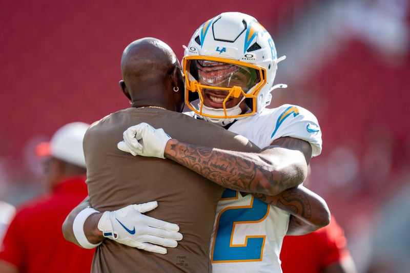 August 23, 2025; Santa Clara, California, USA; Los Angeles Chargers wide receiver Brenden Rice (82) hugs father San Francisco 49ers great Jerry Rice (left) before the game at Levi's Stadium. Mandatory Credit: Kyle Terada-Imagn Images