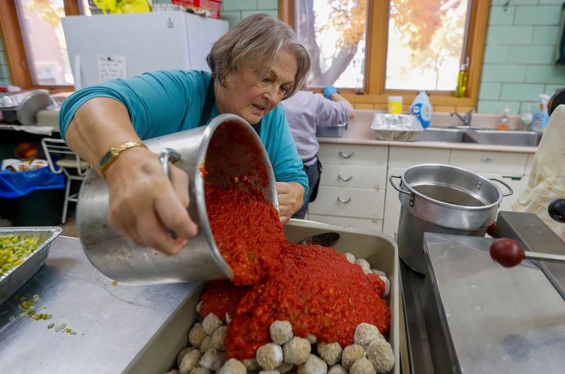 Beth Haasl adds pasta sauce to a pan of meatballs on Friday, November 7, 2025, at Trinity Lutheran Church in Green Bay, Wis. Rooted In Co. used 218 pounds of food recovered from Delaware North at Lambeau Field to prepare hundreds of individually packaged meals for those in need across Green Bay.
Tork Mason/USA TODAY NETWORK-Wisconsin