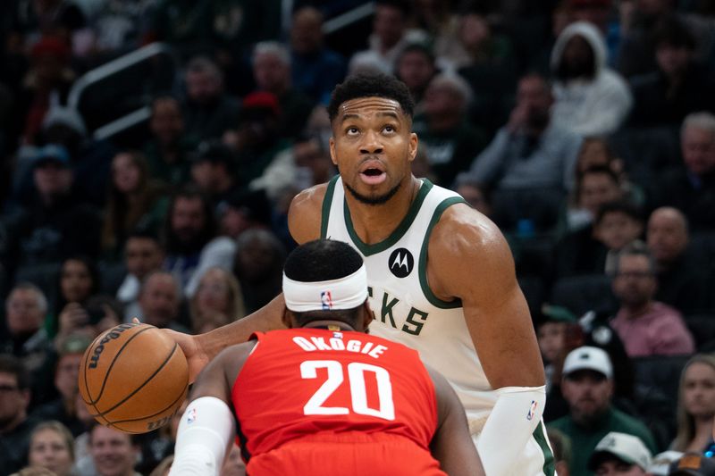 Milwaukee Bucks forward Giannis Antetokounmpo (34) prepares to dribble past Houston Rockets guard Josh Okogie (20) at Fiserv Forum in Milwaukee, Wisconsin, on the afternoon of Nov. 9, 2025. The Bucks lost to the Rockets 122-115.