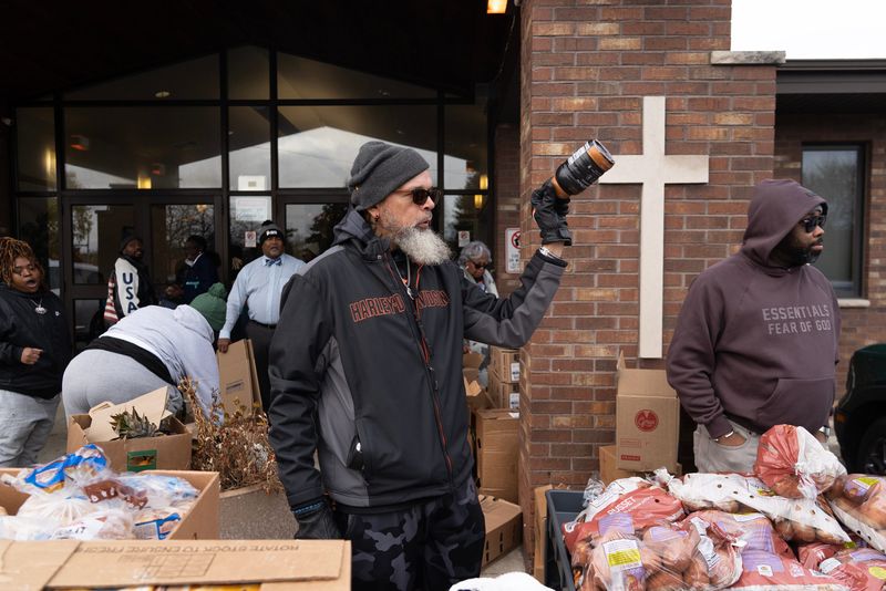 Thomas Lindenberg helps organize and pass out Thanksgiving baskets at Way of The Cross Missionary Baptist Church in Milwaukee, Wisconsin, on the afternoon of Nov. 9, 2025.
