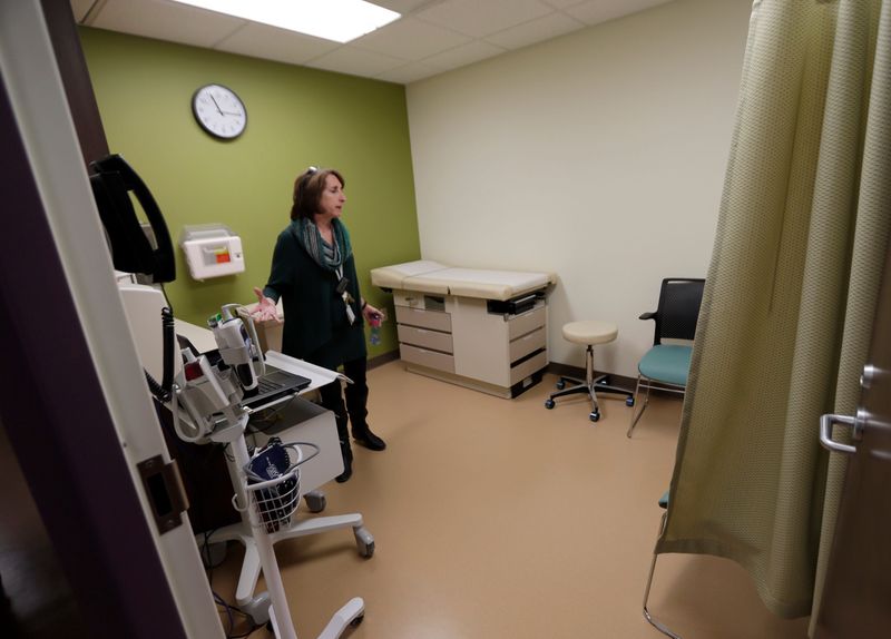 Deb Bretl, a nurse practitioner talks about the features of one of the Sojourner Family Peace Center's exam rooms. City leaders, funders, partners and residents got their first comprehensive tour of the new Sojourner Family Peace Center at 619 W. Walnut St. in Milwaukee, February 4, 2016. The new facility puts Milwaukee firmly in the center of the growing movement to centralize services for domestic violence victims and their children. Spanning 70,000 square feet, the facility will be the largest of the roughly 80 such family justice centers operating in the country, and it's among a handful that use a model of providing shelter, child protection and core health services in one place. The women and families currently living in Sojourner's shelter will move in to the new building after Thursday's open house. Once they move in, the shelter will be secured and no longer open to the public.