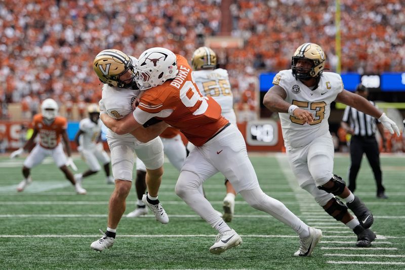 Nov 1, 2025; Austin, Texas, USA; Texas Longhorns defensive lineman Ethan Burke (91) sacks Vanderbilt Commodores quarterback Diego Pavia (2) on the one yard line during the second half at Darrell K Royal-Texas Memorial Stadium. Mandatory Credit: Scott Wachter-Imagn Images