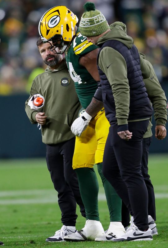Packers center Elgton Jenkins (74) is assisted off the field after an ankle injury against the Eagles on Nov. 10.