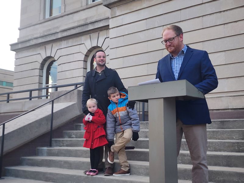 Tyler Martell stands on the steps of the Manitowoc County Courthouse with his family as he announces he will be running for Manitowoc County executive in the 2026 election.