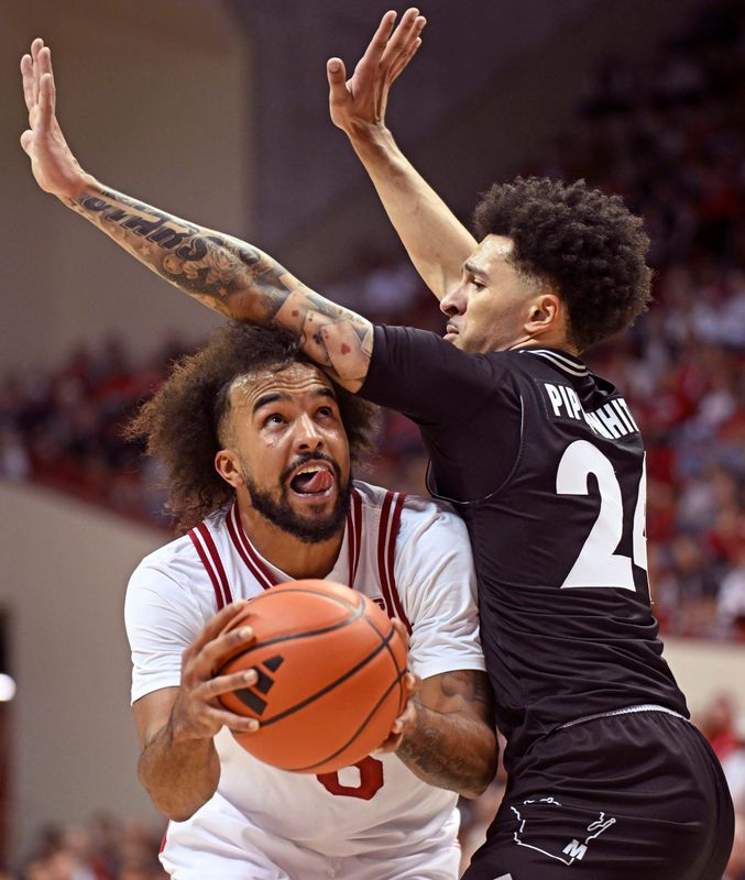 Nov 12, 2025; Bloomington, Indiana, USA; Indiana Hoosiers guard Tayton Conerway (6) goes to the basket against Milwaukee Panthers guard Esyah Pippa-White (24) during the first half at Simon Skjodt Assembly Hall. Mandatory Credit: Robert Goddin-Imagn Images