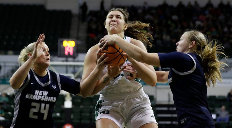 University of Wisconsin-Green Bay's Meghan Schultz, center, drives to the hoop on Nov. 5 during the Phoenix game against the University of New Hampshire at the Kress Events Center in Green Bay.