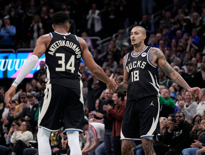 Milwaukee Bucks forward Giannis Antetokounmpo (34) congratulates Milwaukee Bucks forward Kyle Kuzma (18) after scoring during the second half of the game against the Charlotte Hornets on Friday November 14, 2025 at Fiserv Forum in Milwaukee, Wisconsin.
