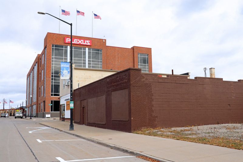 Boards cover the windows of the former Eagle Nation Cycles at 206 Main St. in Neenah.