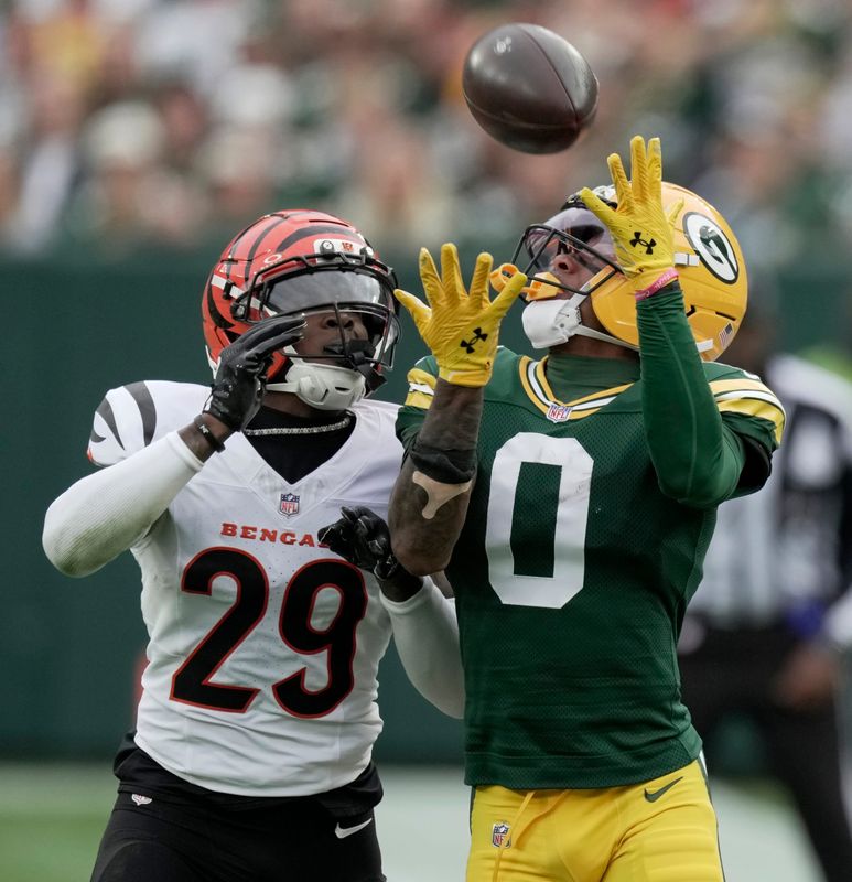 Green Bay Packers wide receiver Matthew Golden (0) makes a 35-yard reception while being covered by Cincinnati Bengals cornerback Cam Taylor-Britt (29) during the second quarter of their game Sunday, October 12, 2025 at Lambeau Field in Green Bay, Wisconsin.