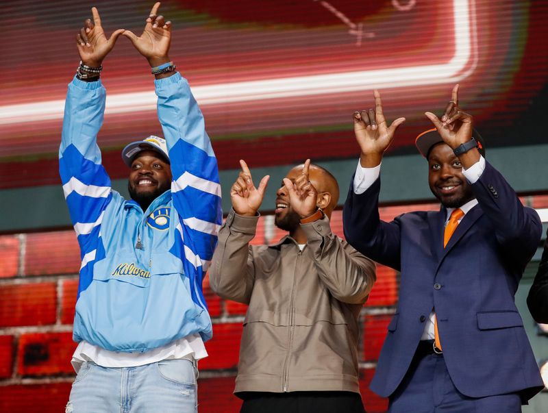 Former Wisconsin running backs Melvin Gordon, left, James White, center, and Montee Ball, right, make â€œWâ€ gestures for the crowd before the second round of the 2025 NFL Draft on Friday, April 25, 2025, at Lambeau Field in Green Bay, Wisconsin. The draft runs through April 26.
Tork Mason/USA TODAY NETWORK-Wisconsin
