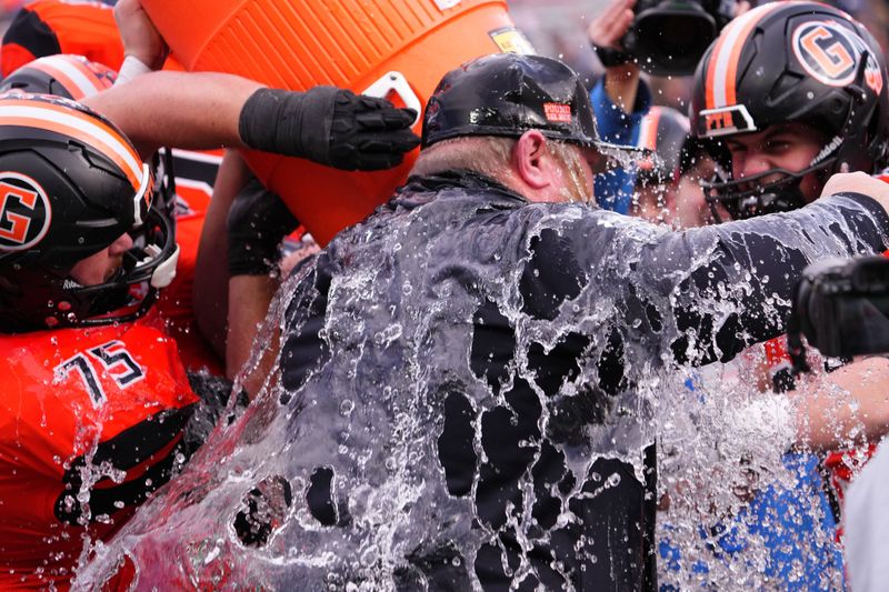 Grafton football head coach Jim Norris gets the customary ice bath after his team won the WIAA Division 3 state football championship, 17-15, over Reedsburg at Camp Randall Stadium in Madison on Thursday, Nov. 20, 2025.