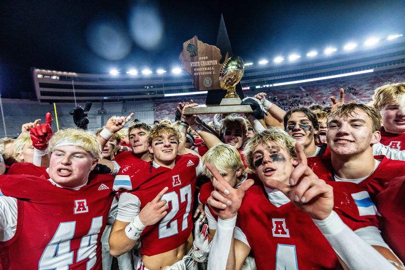 Arrowhead players celebrate with the gold trophy after defeating Bay Port, 18-15, in the WIAA Division 1 state football championship game at Camp Randall Stadium in Madison on Friday, Nov. 21, 2025.
