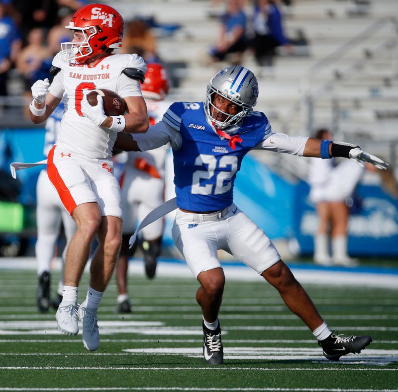 Sam Houston wide receiver Grady O'Neill (6) spins away from Middle Tennessee safety Juwon Gaston (22) during the NCAA college football game on Saturday, Nov. 22, 2025, at Middle Tennessee.