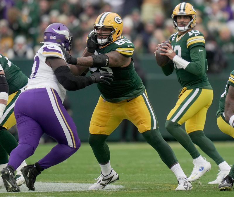 Green Bay Packers guard Aaron Banks (65) provides pass protection for quarterback Jordan Love (10) during the first quarter of their game against the Minnesota Vikings Sunday, November 23, 2025 at Lambeau Field in Green Bay, Wisconsin.