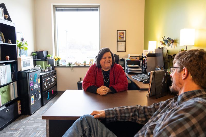Nick Battiola talks with advocate Pam Malin in her office at Disability Rights Wisconsin in Green Bay, Wisconsin, on the morning of Nov. 24, 2025.
