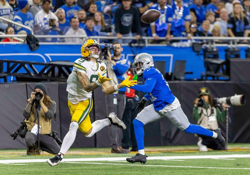 Nov 27, 2025; Detroit, Michigan, USA; Green Bay Packers wide receiver Christian Watson (9) catches a pass against Detroit Lions cornerback Amik Robertson (21) during the third quarter at Ford Field. Mandatory Credit: David Reginek-Imagn Images