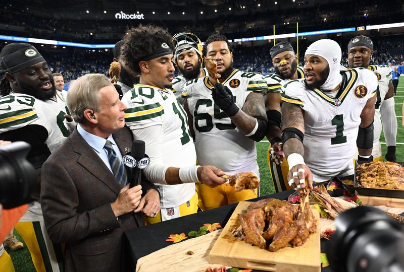 Nov 27, 2025; Detroit, Michigan, USA; Green Bay Packers quarterback Jordan Love (10), Green Bay Packers guard Aaron Banks (65), Green Bay Packers defensive end Micah Parsons (1) eat turkey after defeating the Detroit Lions at Ford Field. Mandatory Credit: Lon Horwedel-Imagn Images