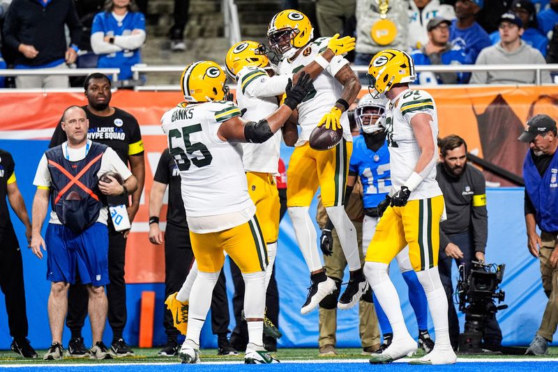 Green Bay Packers wide receiver Dontayvion Wicks (13) celebrates a touchdown against Green Bay Packers during the first half at Ford Field in Detroit on Thursday, Nov. 27, 2025.