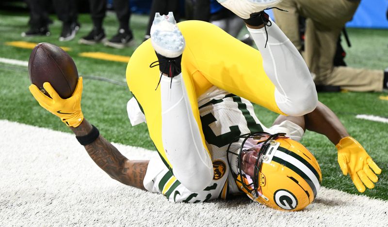 Nov 27, 2025; Detroit, Michigan, USA; Green Bay Packers wide receiver Dontayvion Wicks (13) catches a pass for a touchdown against the Detroit Lions during the second quarter at Ford Field. Mandatory Credit: Lon Horwedel-Imagn Images