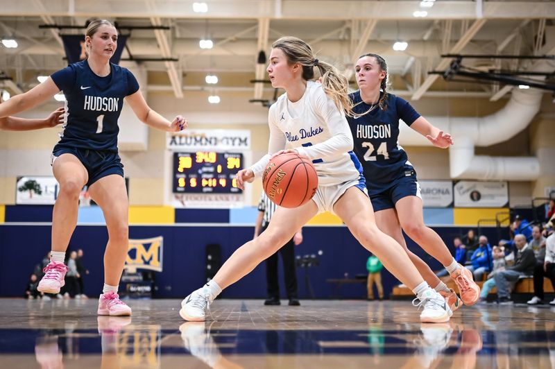 Whitefish Bay's Madeline Volpe (2) handles the ball along the baseline under pressure from Hudson guard Ally Yaeger (1) and Hudson guard Devin Larson (24) in a game in the Kettle Moraine Thanksgiving Classic on Friday, November 28, 2025, at the Kettle Moraine High School in Wales, Wisconsin.