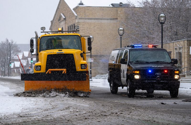 A Milwaukee Public Works snowplow cleans the streets near Cathedral Square park on Saturday November 29, 2025 in Milwaukee, Wisconsin. A winter storm was expected to bring 8 to 12 inches of snow to southern Wisconsin.