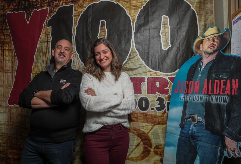Randy “Shotgun” Shannon and Natalie "Nat" Gross pose for a portrait in the Y100 (WNCY-FM) studio on Dec. 1 at Midwest Communications Inc. in Bellevue. Gross is Shannon's new co-host on the Y100 morning show.