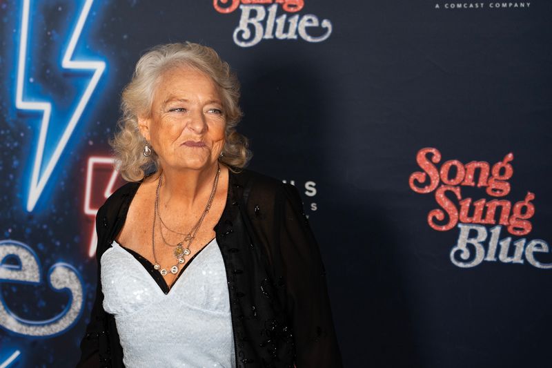 Singer Claire Sardina, subject of the movie “Song Sung Blue,” walks the blue carpet during the Milwaukee premiere at the Oriental Theatre in Milwaukee, Wisconsin, on the evening of Dec. 2, 2025.