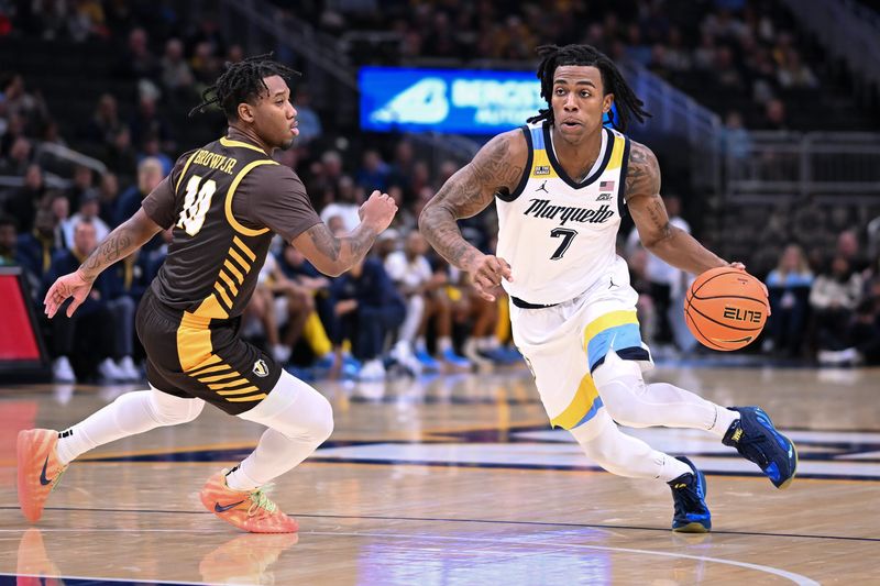 Marquette guard Zaide Lowery (7) drives to the basket past Valparaiso guard Mark Brown Jr. (10) in the first half of a game Tuesday, December 2, 2025, at Fiserv Forum in Milwaukee, Wisconsin.