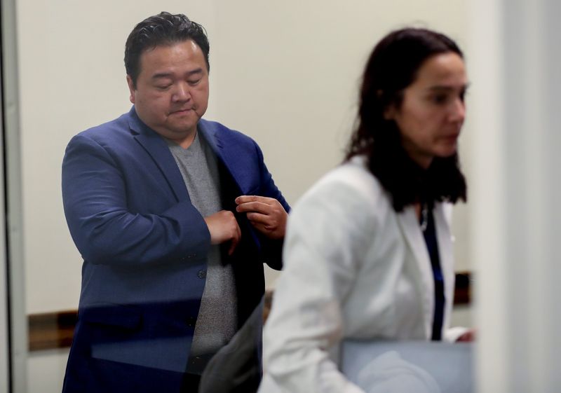 Former Green Bay School Board member Kou Lee of Hobart leaves a Brown County courtroom Dec. 3 after a preliminary hearing.