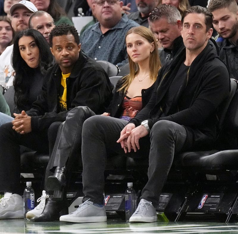 Mallory Edens (center), daughter of Milwaukee Bucks co-owner Wes Edens, will represent the Bucks at the NBA draft lottery on May 10. She's pictured here courtside at a Bucks game in 2022 with former Green Bay Packers quarterback Aaron Rodgers and wide receiver Randall Cobb.
