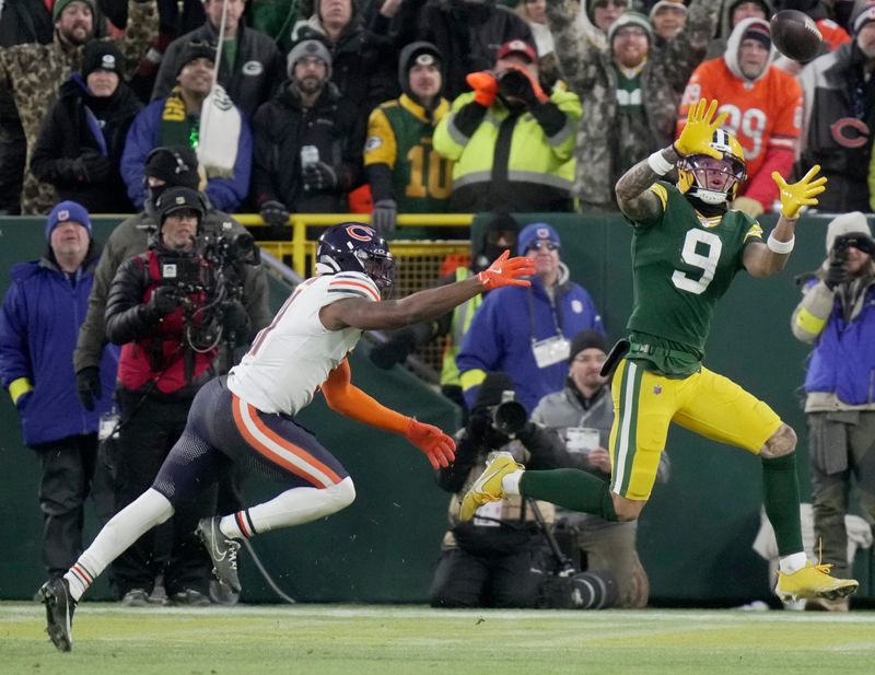 Green Bay Packers wide receiver Christian Watson (9) catches a touchdown pass while being covered by Chicago Bears safety Kevin Byard III (31) during the second quarter of their game Sunday, December 7, 2025 at Lambeau Field in Green Bay, Wisconsin.